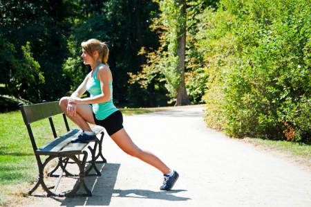 Young woman runner stretching before runningの写真素材