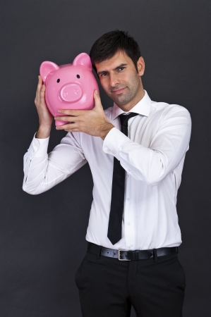 Businessman with a piggy bankの写真素材