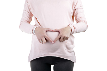 Happy pregnant woman - isolated over a white background

の写真素材