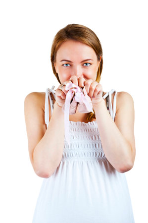 Pregnant belly with newborn baby booties close up over white 

の写真素材