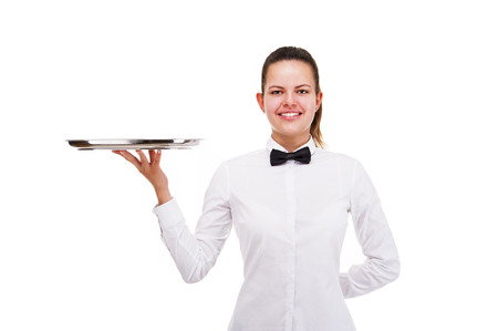 Young woman in waiter uniform holding tray isolated over white background.の写真素材