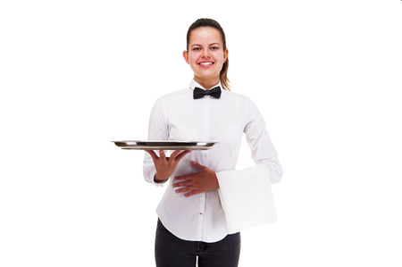 Young woman in waiter uniform holding tray isolated over white background.の写真素材