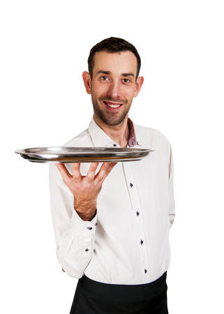 Waiter holding tray with smile, isolated over white background.の写真素材
