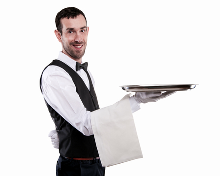 Waiter holding tray. Isolated over white background. Smiling butler.の写真素材