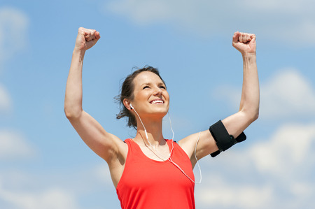 Fit woman jump happy of victory winns.の写真素材
