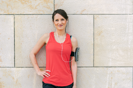 Fit woman rest after jogging and listening music.の写真素材