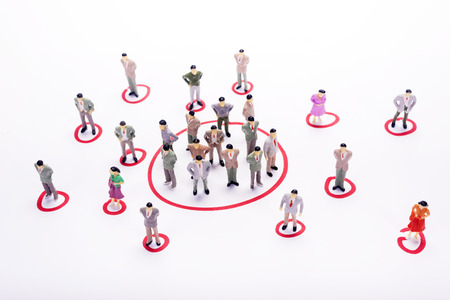 Miniature business people in conection scheme over white backdrop or background.の写真素材