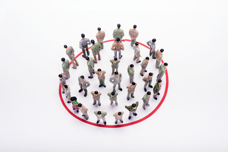 Miniature business people standing in circle over backdrop or background.の写真素材