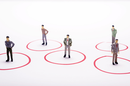 Miniature business people in conection scheme over white backdrop or background.の写真素材