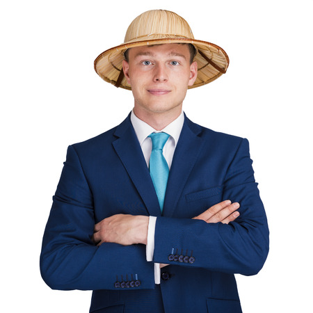 businessman with suit and crossed arms with travel hat smiling.の写真素材