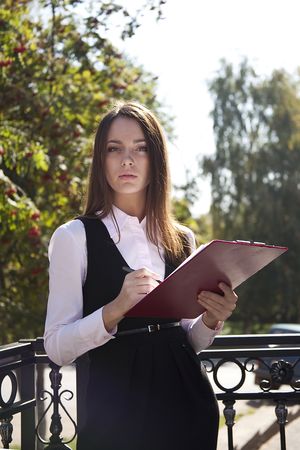 Young woman work with pen in parkの写真素材