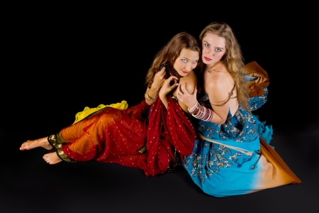 two young attractive woman look at you in indian costumeの写真素材