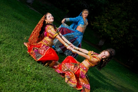 Young woman traditional indian costume, dance on grass