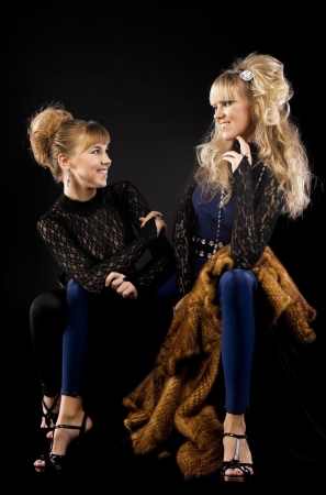 Two pretty sisters talk in lace costumeの写真素材