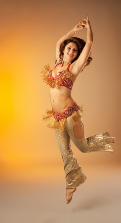 woman jump in belly dance with finger cymbals