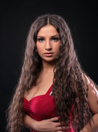 Young beauty girl with amazing  curly hair in redの写真素材