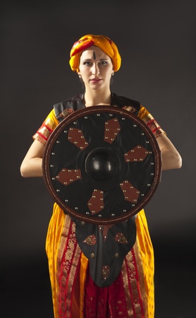 Beauty woman posing with shield - arabian costumeの写真素材