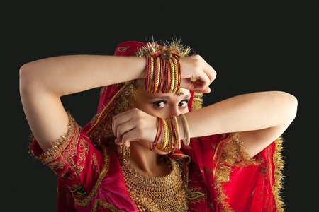 young beauty girl posing in red oriental indian costume closeup portrait