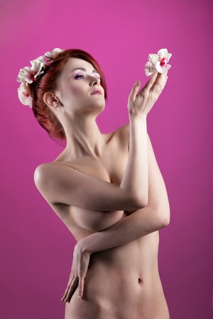 Young beauty naked woman with flower and garlandの写真素材