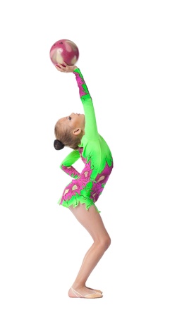 Young teenager girl doing exercise with acrobatics ball isolatedの写真素材