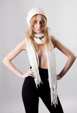 sexy blond woman posing in black panty hose and white cap and scarfの写真素材