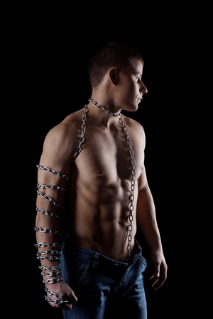 yong beauty man with chain on strong hand portraitの写真素材