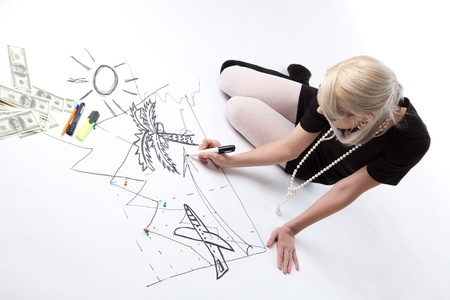 Blond business woman dream about vacation on financial graph isolatedの写真素材