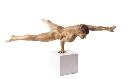 Strong man posing nude stand on hand with metal skinの写真素材