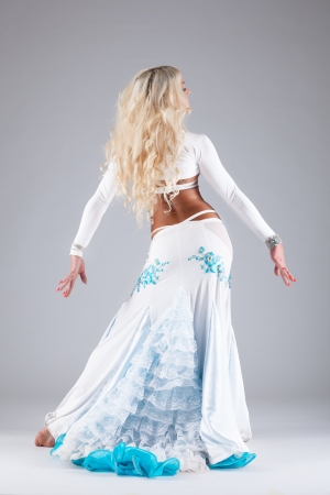 Sexy blond woman posing in white oriental arabian costumeの写真素材