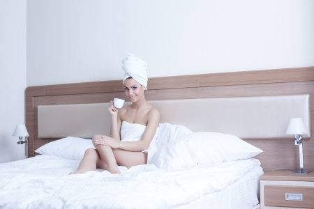 Beautiful brunette woman wearing only towels on her body and headの写真素材