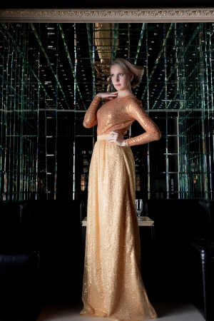 Full length portrait of woman with short hair in beautiful long dressの写真素材