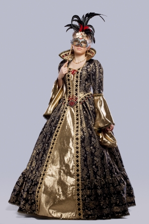 Full length portrait of young girl in carnival costume middle age with maskの写真素材