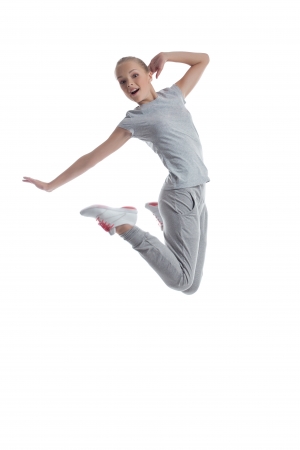 Sporty girl jumping in studio isolated on white backgroundの写真素材