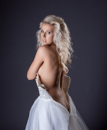 Portrait of sensual curly blonde posing in wedding dress, close-upの写真素材