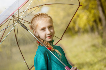 Smiling freckled girl posing with umbrella, close-upの写真素材
