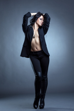 Image of beddable woman posing topless in stylish clothesの写真素材