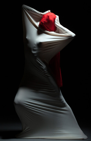 Concept of loneliness - faceless female silhouette in studioの写真素材