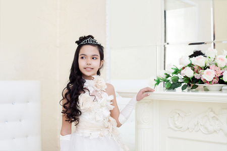 Image of lovely tanned girl posing in elegant white dressの写真素材