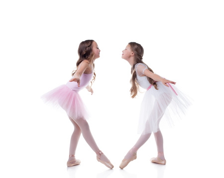 Amusing young ballerinas posing looking at each otherの写真素材