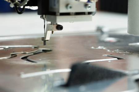 Image of thread and needle on sewing machine, close-up