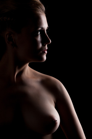 Image of busty young woman posing without bra, close-upの写真素材