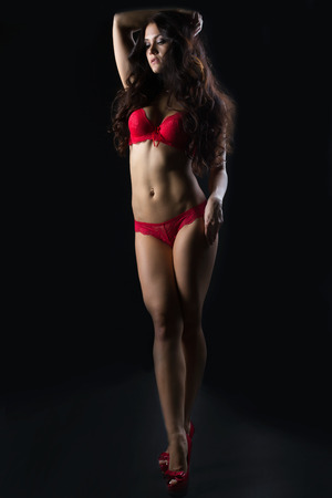 Image of sensual brunette posing in erotic red lingerieの写真素材