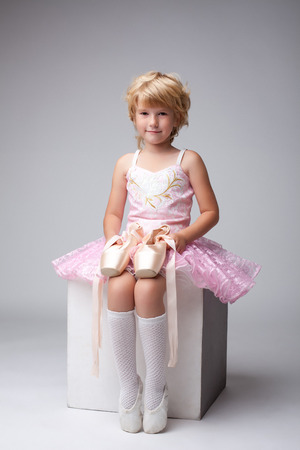 Nice little ballerina posing with pointes at cameraの写真素材