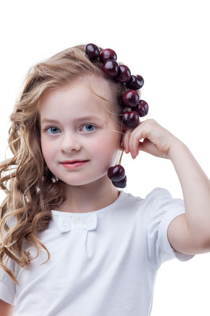Pretty freckled girl posing with cherries, close-upの写真素材