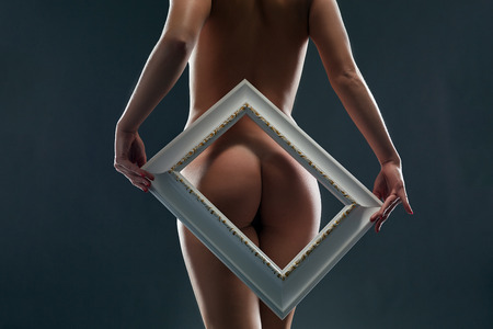 Image of bare womans ass framed, on gray backdropの写真素材