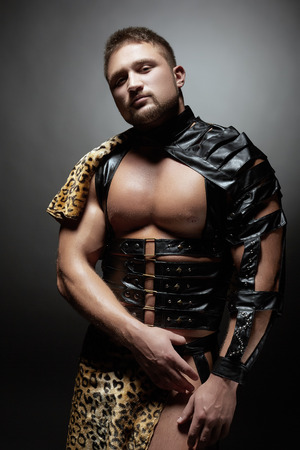 Handsome male dancer posing as prehistoric man, close-upの写真素材