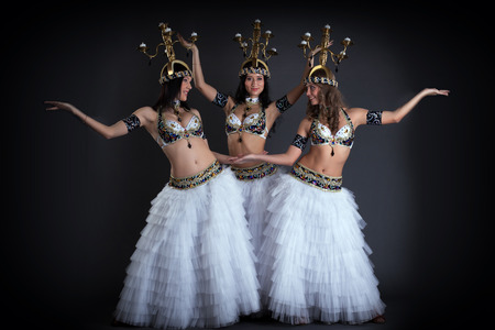 Pretty young girls dancing with chandeliers in studioの写真素材