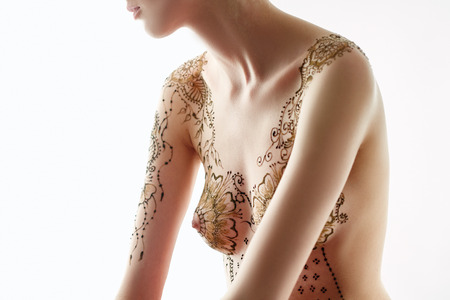 Beautiful topless model with henna patterns on her body, close-upの写真素材
