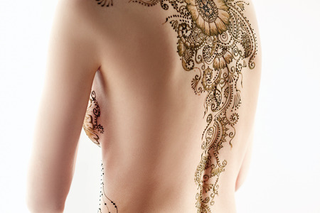 Art of mehndi. Topless model posing back to camera, isolated on whiteの写真素材