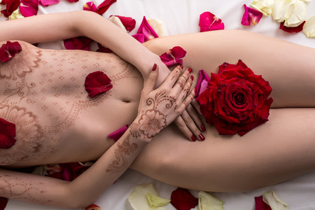 Top view of naked female body with mehendi pattern, close-upの写真素材